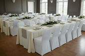 a large ballroom featuring cream tablecloths and taupe runners