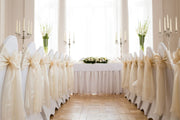 white-chair-covers-with-gold-sash