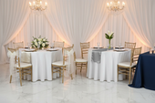 Two elegantly styled round banquet tables side by side