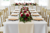 long rectangular banquet table with a lush floral arrangement