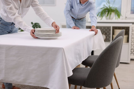 Couple-putting-plates-on-table