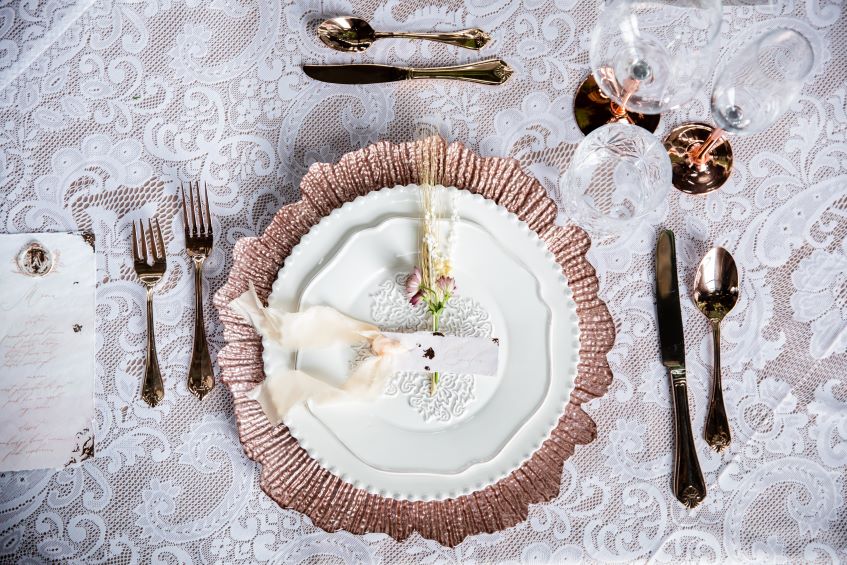 Cutlery-and-charger-plates-on-linens