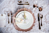 Cutlery-and-charger-plates-on-linens
