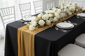 black tablecloth with gold table runner