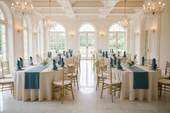 white tablecloth and blue runners with floral centerpieces