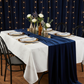 indoor elegant dinner setup showing 10 yards Velvet Fabric Roll - Navy Blue on top of white tablecloth