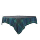 Green and navy plaid tablecloth with red and white accents draped over a rectangular table.