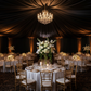 40 yds Satin Fabric Roll - Black ceiling draping for wedding reception with white tablecloth, gold charger plates and chiavari chair