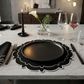 dinner table set with the 4pc/set Signature Scallop Placemats Black/White Trim with black charger plate, and wine glasses