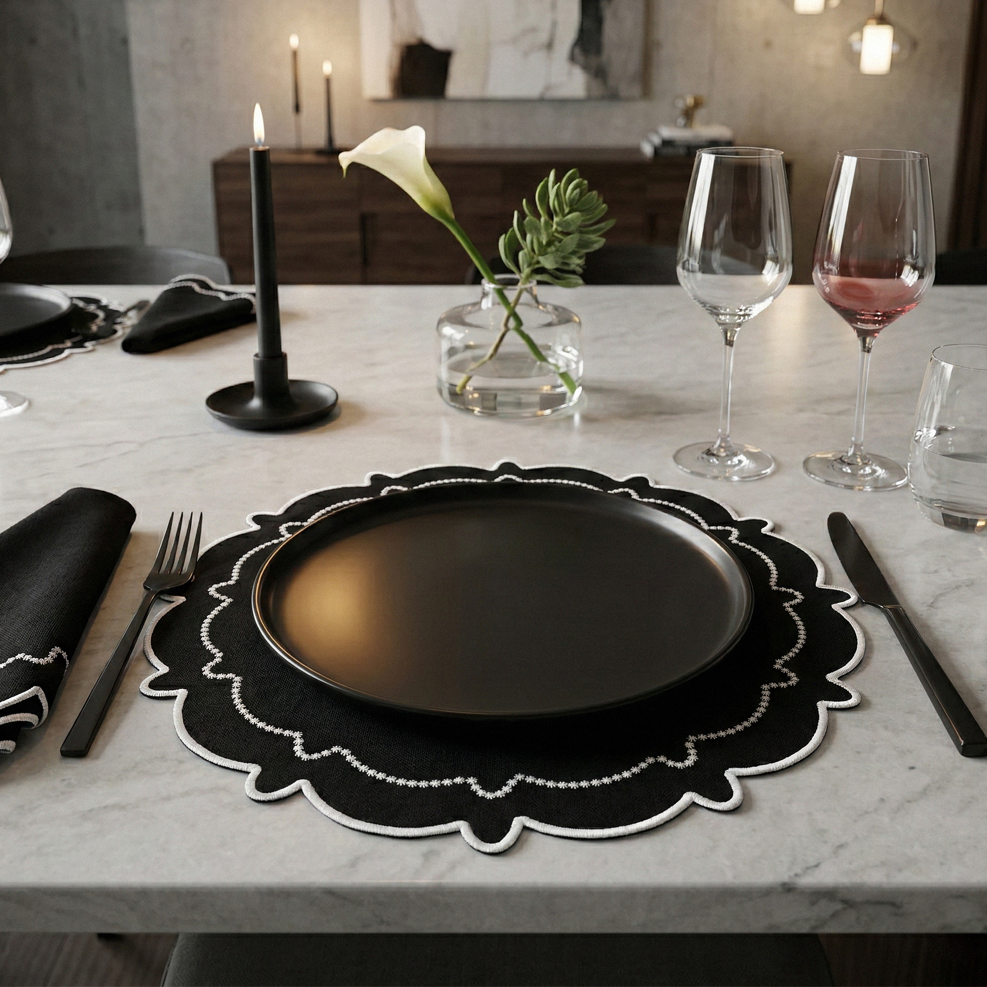 dinner table set with the 4pc/set Signature Scallop Placemats Black/White Trim with black charger plate, and wine glasses