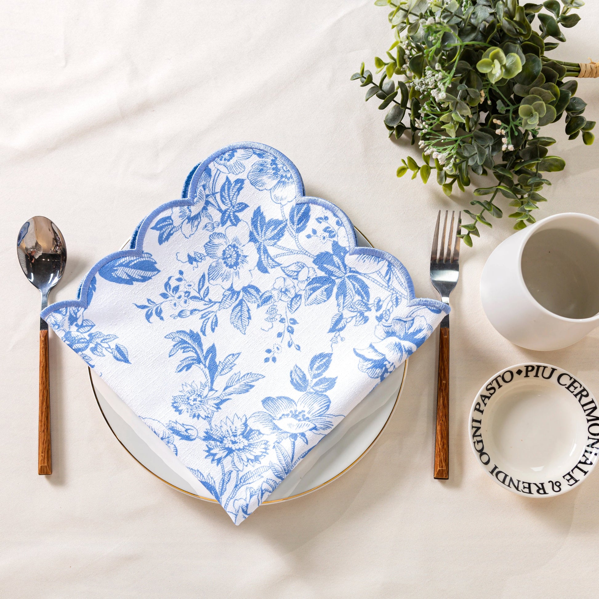 4 pcs/pk French Toile 18"x18" Scalloped Edge Napkins Baby Blue folded on top a white gold trimmed dinner plate
