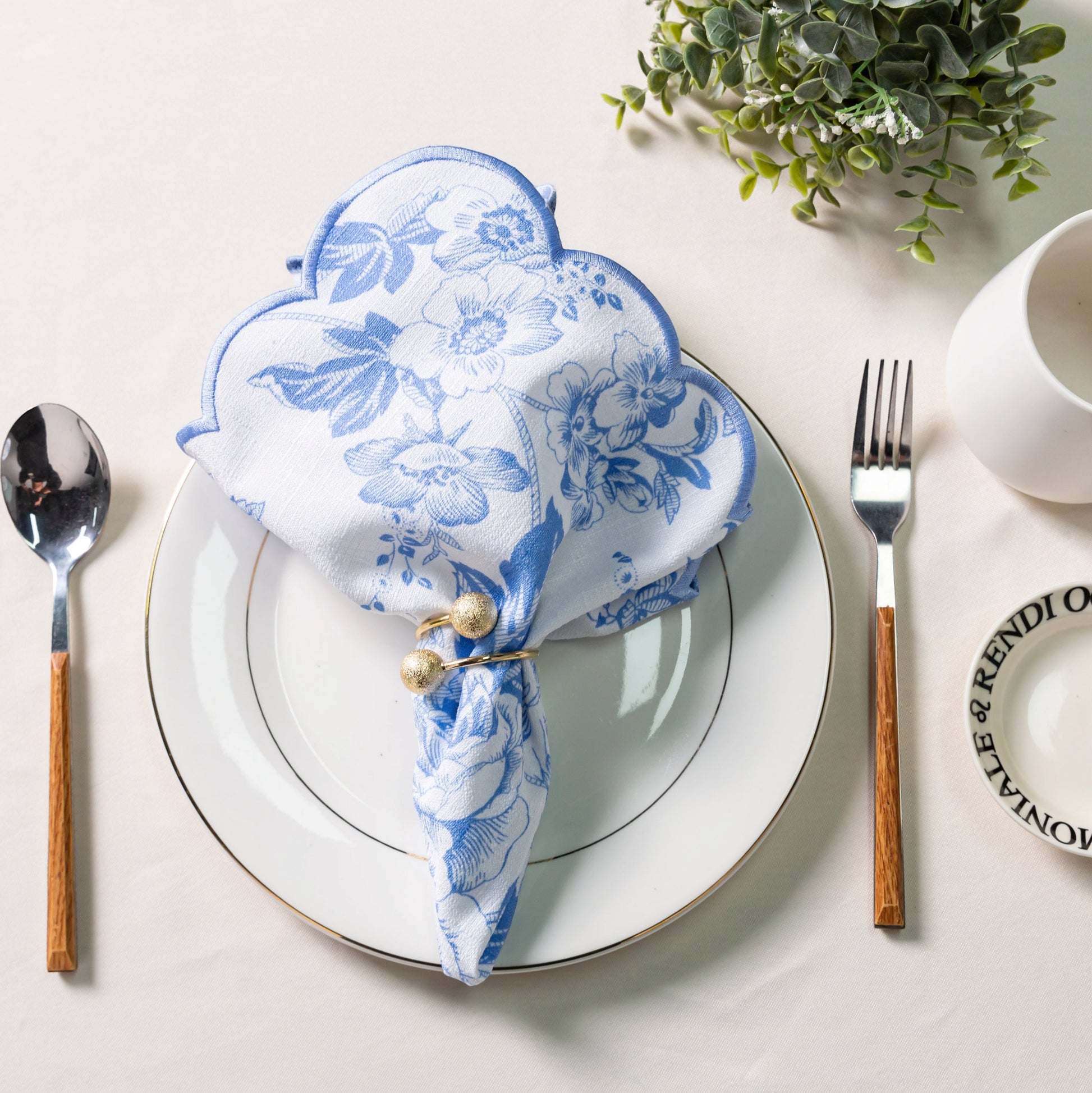 French Toile 18"x18" Scalloped Edge Napkins Baby Blue with a gold napkin ring