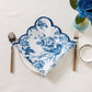 4 pcs/pk French Toile 20"x20" Scalloped Edge Napkins Blue folded on top a white gold trimmed dinner plate
