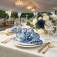 4 pcs/pk French Toile 20"x20" Scalloped Edge Napkins Blue in a scallop fan fold on top of white dinner plates