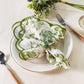 French Toile 20"x20" Scalloped Edge Napkins Olive Green with a eucalyptus napkin ring