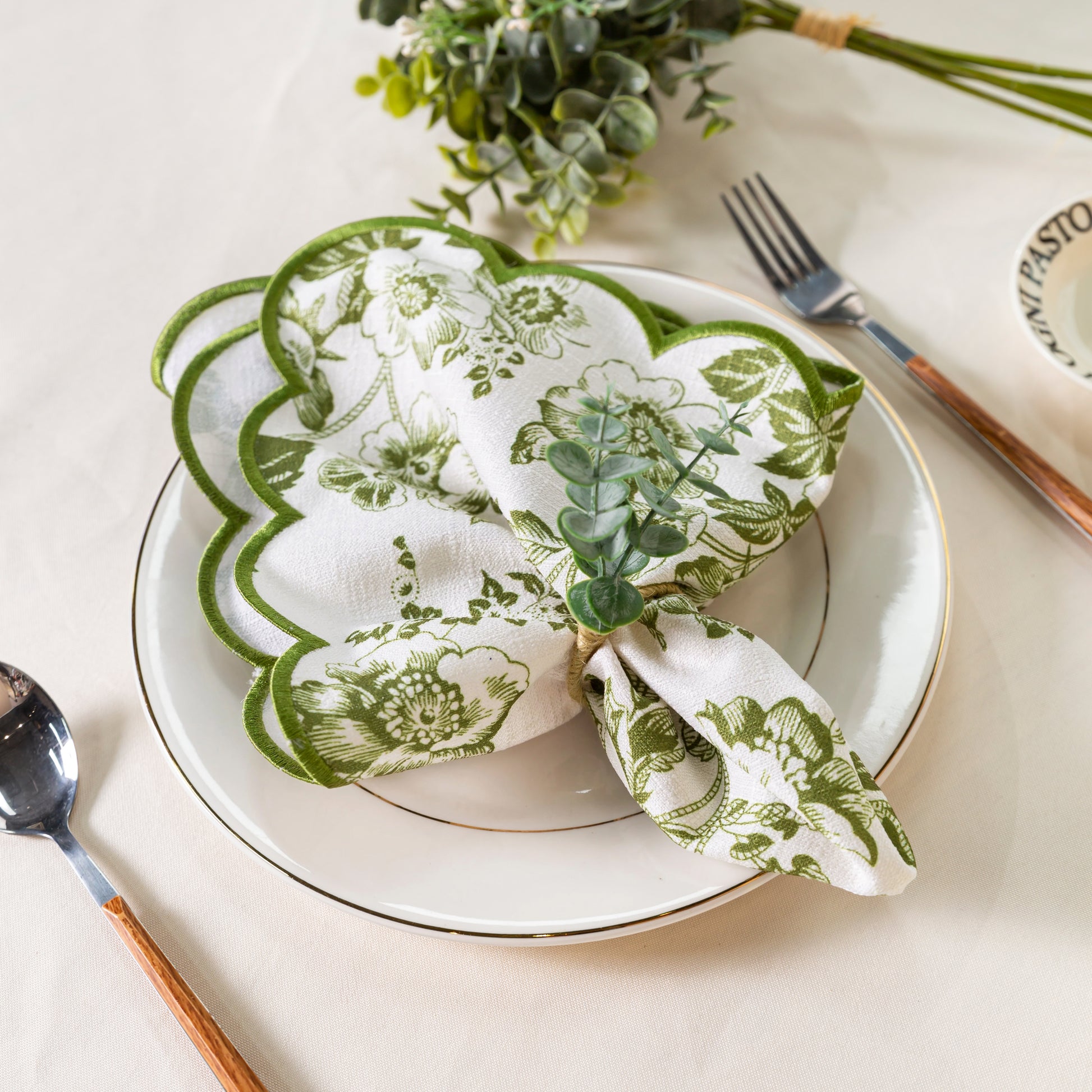 French Toile 20"x20" Scalloped Edge Napkins Olive Green with a eucalyptus napkin ring