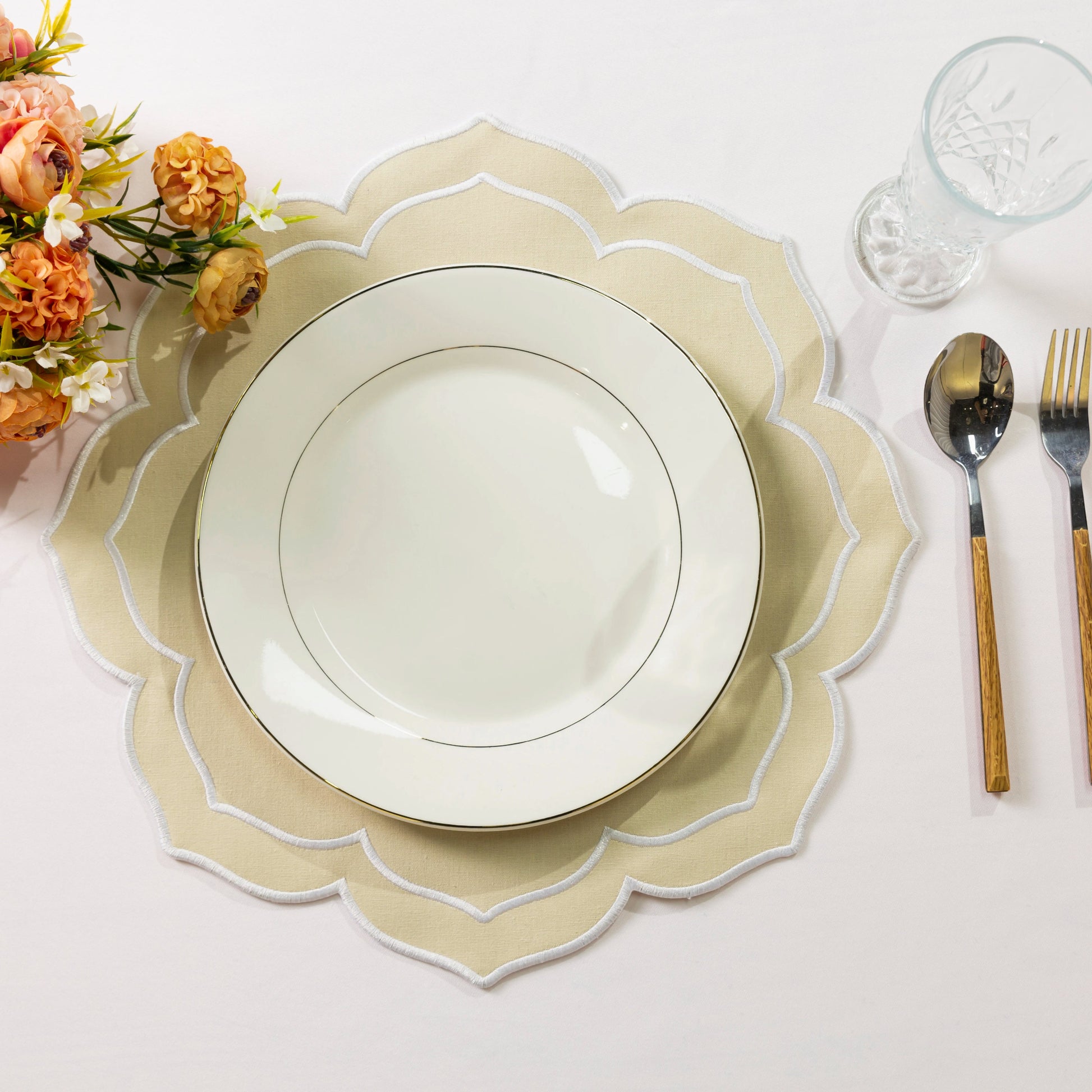 4pc/set Petal Elegance Placemats Champagne/White Trim paired with a white dinner plate on a blush tablecloth, fall florals and silverware