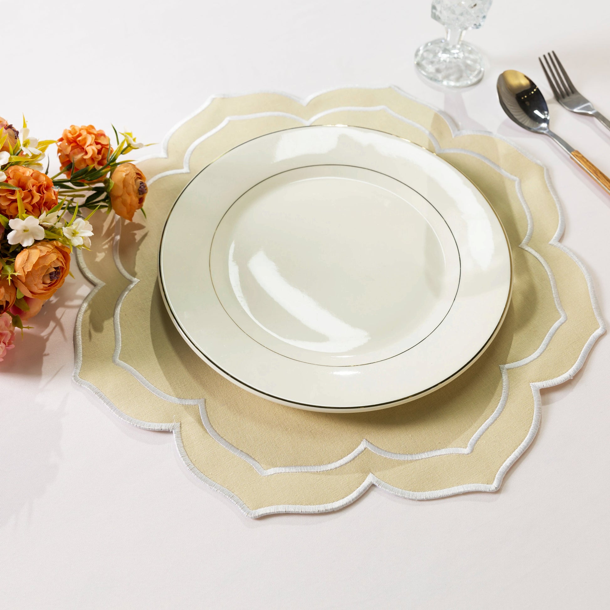 4pc/set Petal Elegance Placemats Champagne/White Trim paired with a white dinner plate on a blush tablecloth, fall florals and silverware
