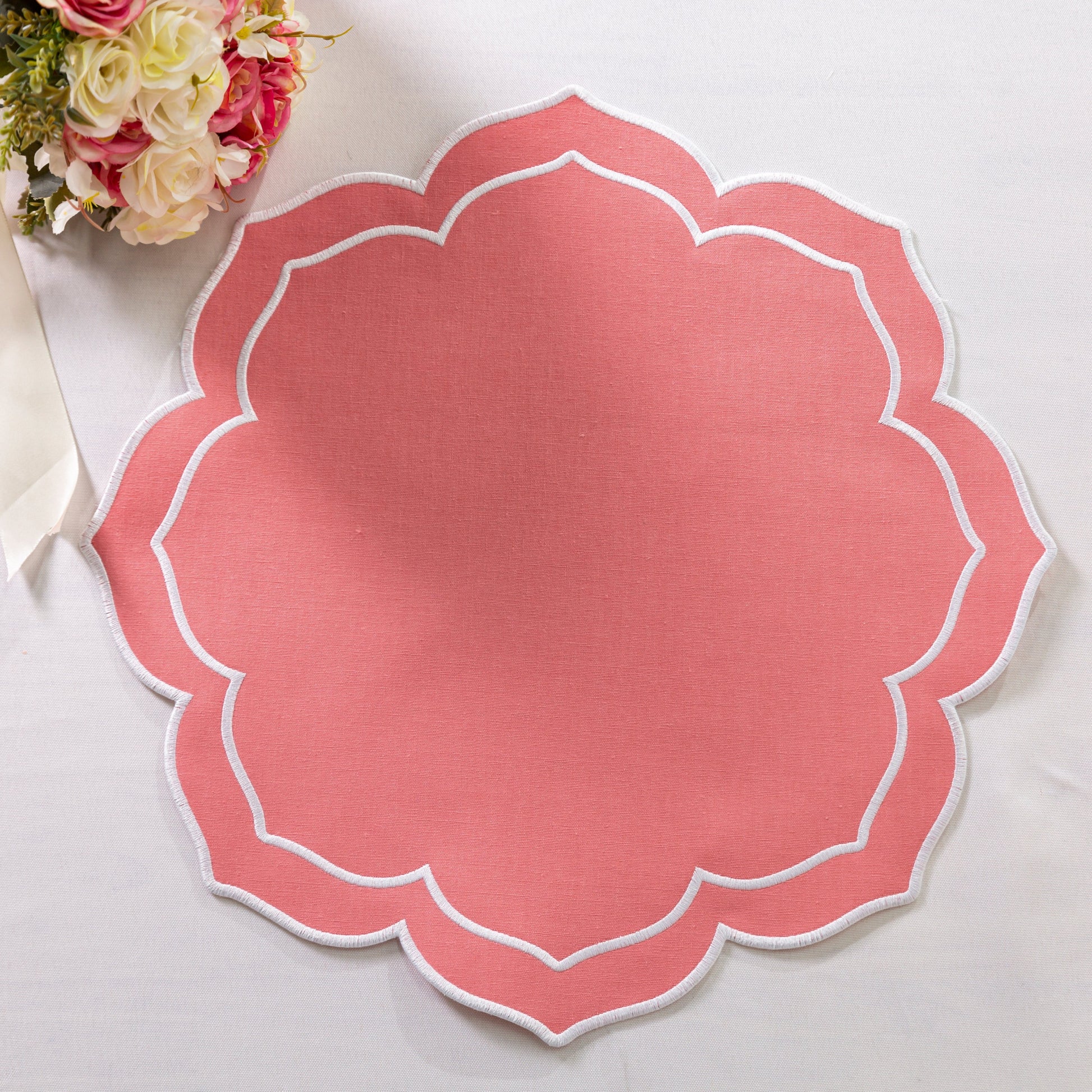 4pc/set Petal Elegance Placemats - Coral/White Trim paired with a white tablecloth, florals and silverware