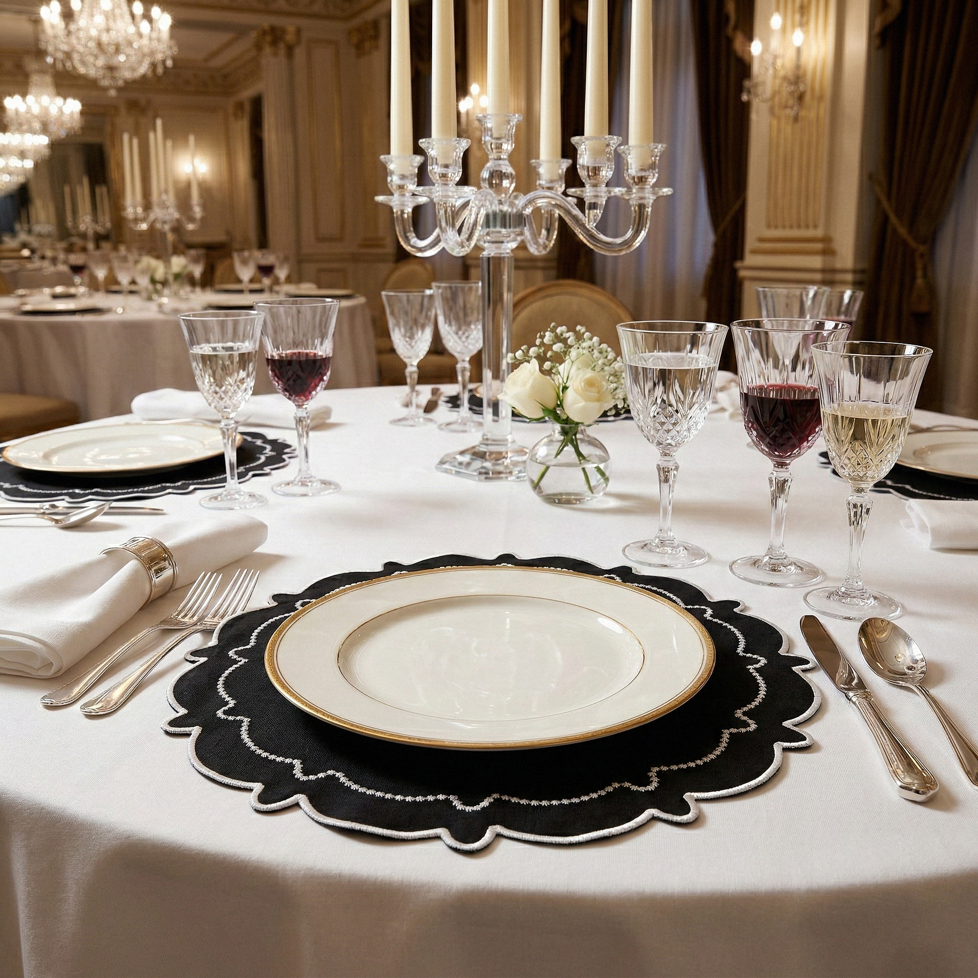dinner table set with the 4pc/set Signature Scallop Placemats Black/White Trim white gold trimmed charger plate, and wine glasses