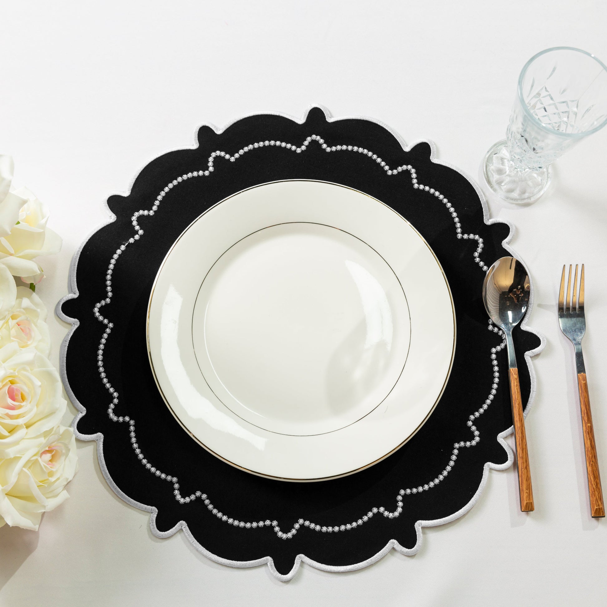 4pc/set Signature Scallop Placemats Black/White with white dinner plate, silverware, wine goblet and florals