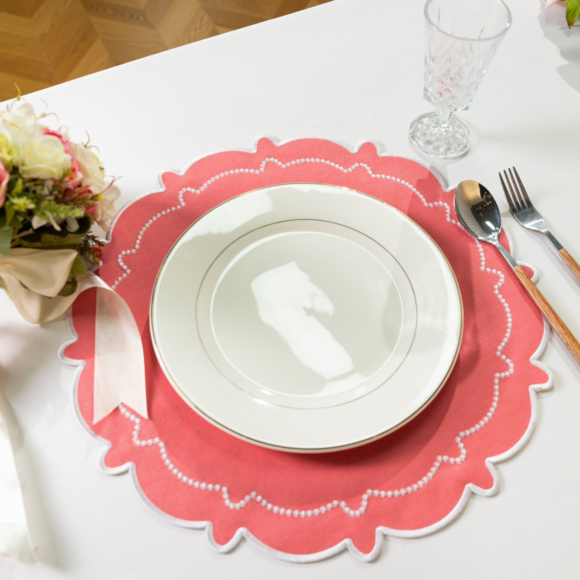 4pc/set Signature Scallop Placemats Coral/White with white dinner plate, silverware, wine goblet and florals