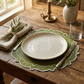 rustic theme with the 4pc/set Signature Scallop Placemats Olive Green/White Trim, burlap napkin with a sprig of rosemary, silverware, and a water glass
