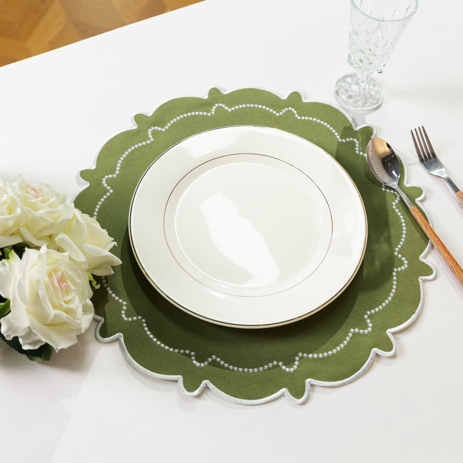 4pc/set Signature Scallop Placemats Olive Green/White with white dinner plate, silverware, wine goblet and florals