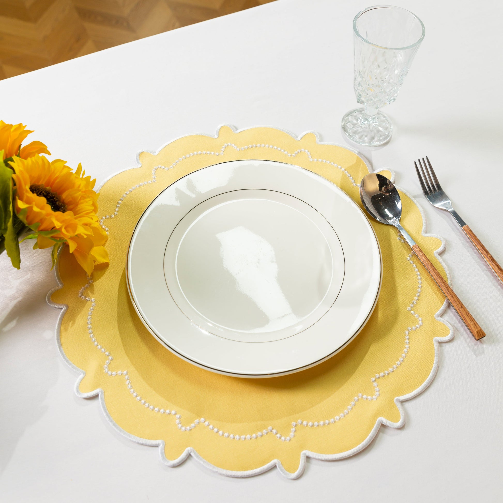 4pc/set Signature Scallop Placemats Pastel Yellow/White with white dinner plate, silverware, wine goblet and florals