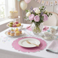 4pc/set Signature Scallop Placemats Pink/White Trim on a white tablecloth with dessert tray and pastel florals for birthday celebration