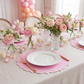 baby shower event with the 4pc/set Signature Scallop Placemats Pink/White Trim and a white dinner plate and pink and white florals