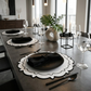4pc/set Signature Scallop Placemats White/Black Trim with black dinner plates on top with black flatware and wiater glasses