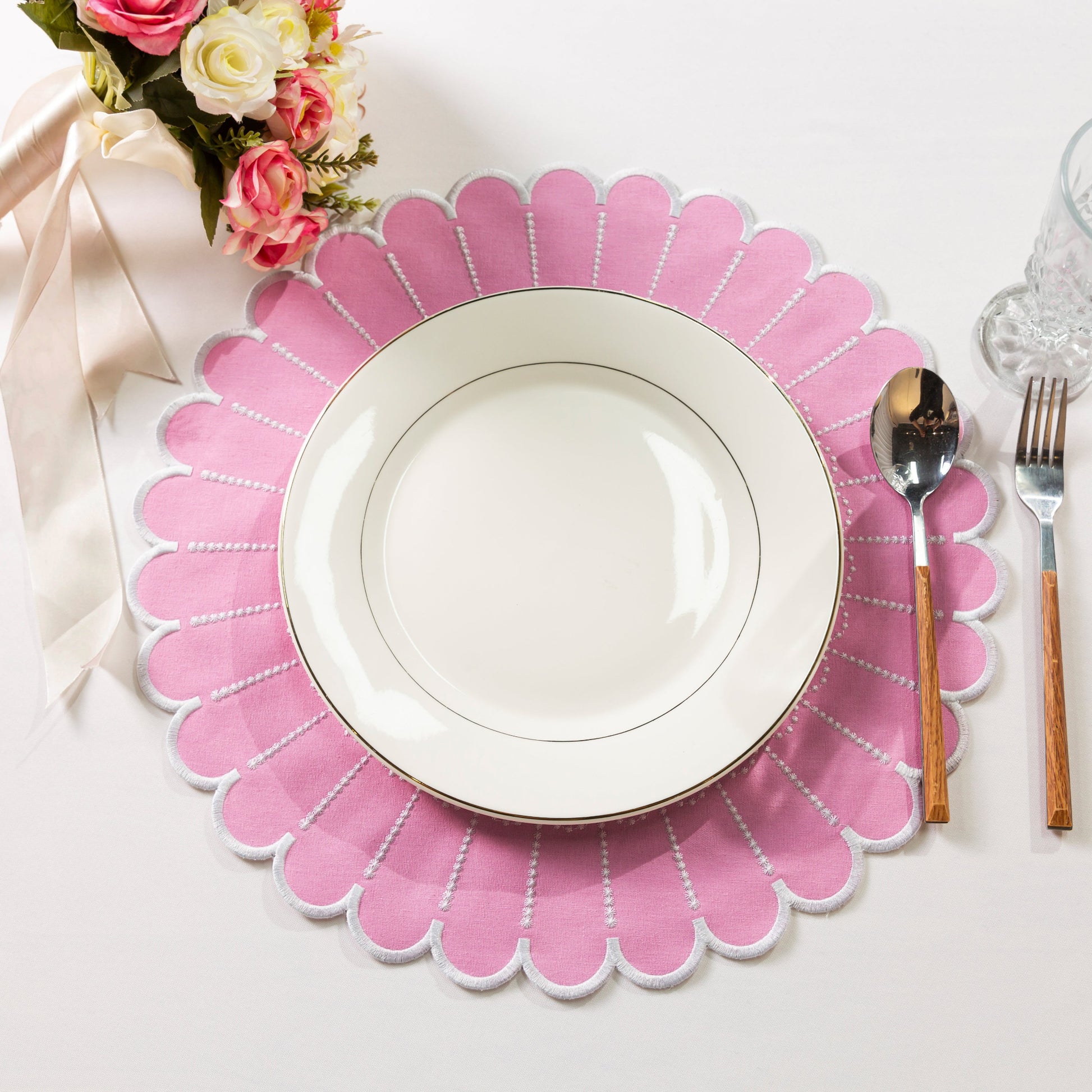 4pc/set Sunburst Edge Placemats Pink/White Trim paired with white dinner plate, florals, and silverware