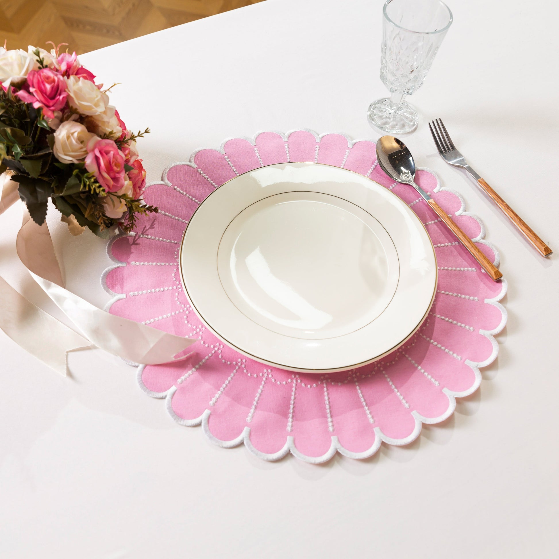 4pc/set Sunburst Edge Placemats Pink/White Trim paired with white dinner plate, florals, and silverware