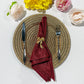 Crinkle Shimmer Napkin 20"x20" - Burgundy folded with a gold bow napkin ring, gold charger plate and silverware