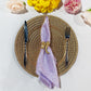 5 pcs/pk Crinkle Shimmer Napkin 20"x20" Lavender folded with a gold bow napkin ring, gold charger plate and silverware