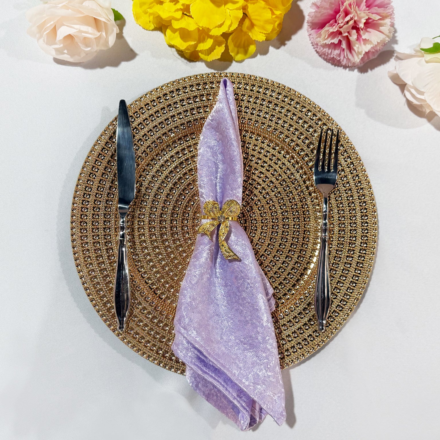 5 pcs/pk Crinkle Shimmer Napkin 20"x20" Lavender folded with a gold bow napkin ring, gold charger plate and silverware