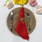 5 pcs/pk Crinkle Shimmer Napkin 20"x20" Red folded with a gold bow napkin ring. gold charger plate and silverware