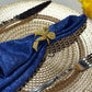 5 pcs/pk Crinkle Shimmer Napkin 20"x20" Royal Blue fold napkin with a gold bow napkin ring on a gold charger plate close up