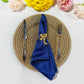 5 pcs/pk Crinkle Shimmer Napkin 20"x20" Royal Blue folded with gold bow napkin ring, gold charger plate and silverware