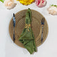 5 pcs/pk Crinkle Shimmer Napkin 20"x20" Willow Green with a gold bow napkin ring on a gold charger plate and silverware