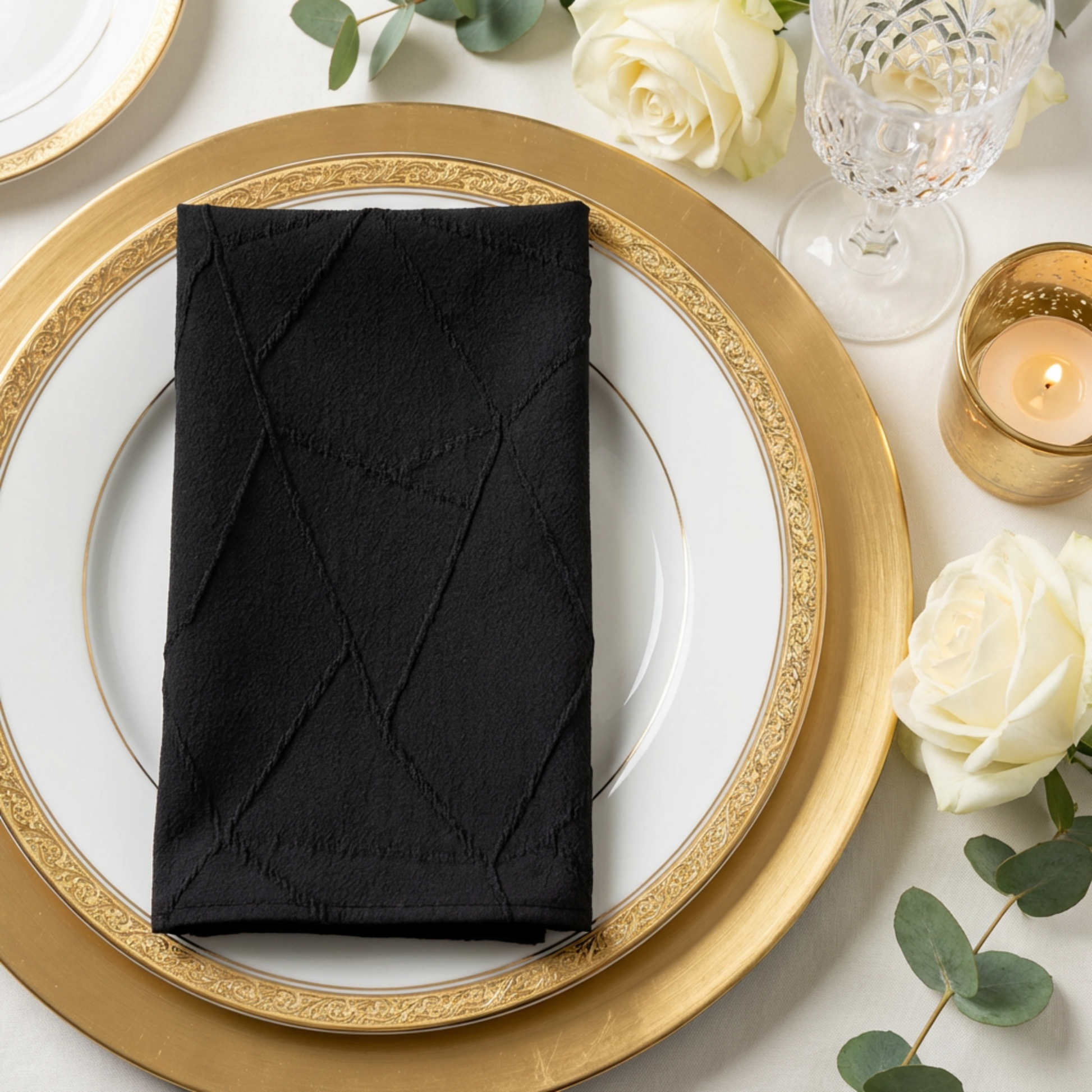 5 pcs/pk Embossed Geometric Jacquard Napkin 20"x20" Black folded in a rectangular shape ontop a gold/white charger plate setting