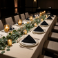dinner gathering with 5 pcs/pk Embossed Geometric Jacquard Napkin 20"x20" Black, votive candles, and eucalytpus greenery table runner