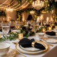 5 pcs/pk Embossed Geometric Jacquard Napkin 20"x20" Black wedding receoption with gold/white charger plates, wine goblets, and votive candles, on top a white tablecloth
