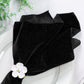 5 pcs/pk Glitter Velvet 20"x20" Linen Napkin Black close up of the napkin on a white charger plate and white flower napkin ring