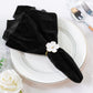 5 pcs/pk Glitter Velvet 20"x20" Linen Napkin Black on a white charger plate with a white flower napkin ring