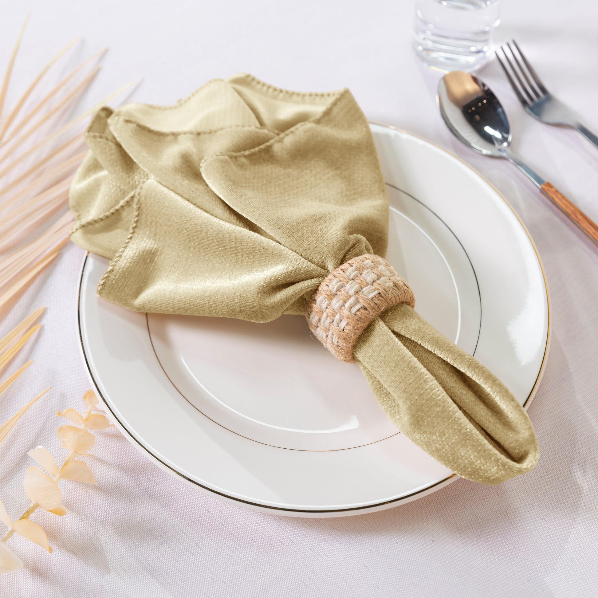 5 pcs/pk Glitter Velvet 20"x20" Linen Napkin Champagne on top with a white charger plate ad burlap napkin ring