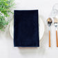 5 pcs/pk Glitter Velvet 20"x20" Linen Napkin folded on a white charger plate, greenery and silverware