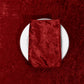 Velvet 20"x20" Linen Napkin Apple Red folded on a charger plate on top of a apple red velvet tablecloth