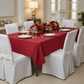 60"x120" Rectangular Premium Polyester Tablecloth - Apple Red on top of 6ft rectangular table| white chair cover | white dinner and charger plate